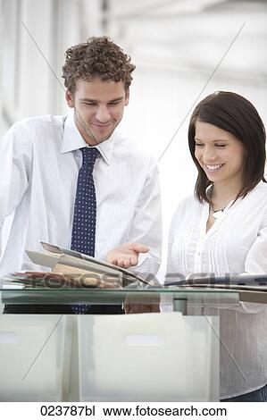 portrait of businessman and female colleague discussing document View Large Photo Image Stock Image - portrait of businessman and female colleague discussing document. Fotosearch