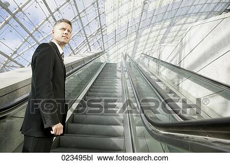portrait of businessman on escalator View Large Photo Image Stock Image - portrait of businessman on escalator. Fotosearch