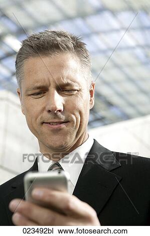 portrait of businessman with mobile phone View Large Photo Image Stock Image - portrait of businessman with mobile phone. Fotosearch