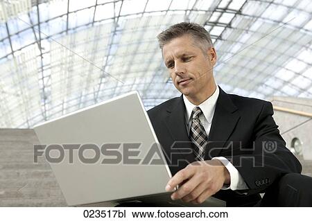 portrait of businessman working with laptop computer View Large Photo Image Stock Image - portrait of businessman working with laptop computer. Fotosearch