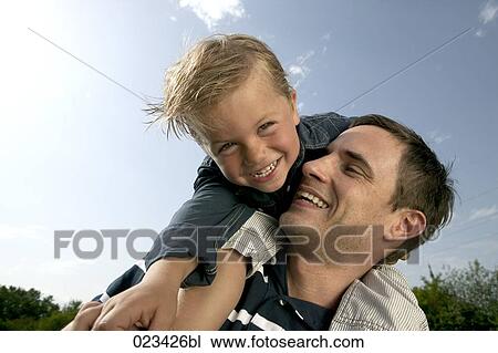portrait of father carrying son piggyback View Large Photo Image Stock Image - portrait of father carrying son piggyback. Fotosearch