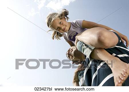 portrait of father carrying young girl piggyback View Large Photo Image Stock Image - portrait of father carrying young girl piggyback. Fotosearch