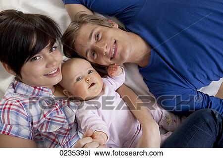 portrait of happy young family with baby girl View Large Photo Image Stock Image - portrait of happy young family with baby girl. Fotosearch