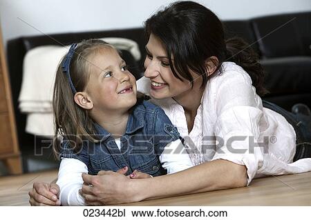 portrait of mother and young daughter lying on floor at home View Large Photo Image Stock Image - portrait of mother and young daughter lying on floor at home. Fotosearch