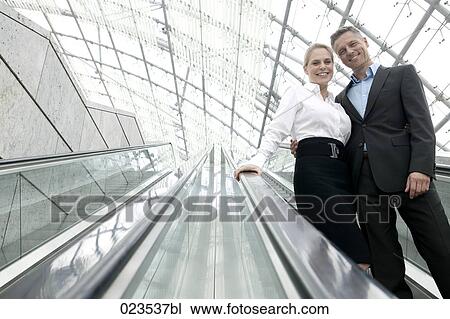 portrait of two business people on escalator View Large Photo Image Stock Image - portrait of two business people on escalator. Fotosearch