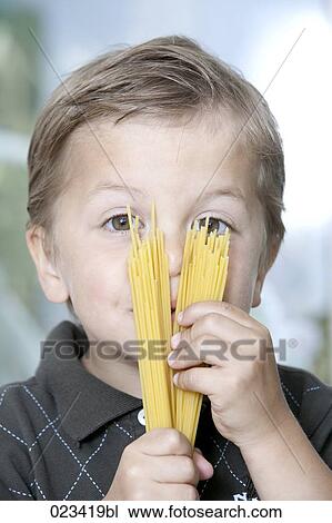 portrait of young boy holding spaghetti View Large Photo Image Stock Image - portrait of young boy holding spaghetti. Fotosearch