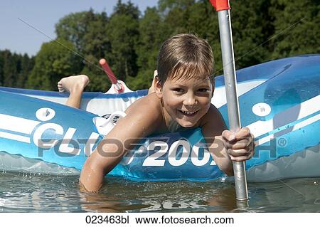 portrait of young boy in rubber boat on lake View Large Photo Image Stock Image - portrait of young boy in rubber boat on lake. Fotosearch