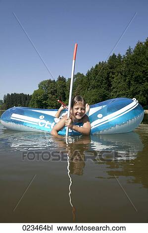 portrait of young boy in rubber boat on lake View Large Photo Image Stock Image - portrait of young boy in rubber boat on lake. Fotosearch