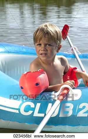 portrait of young boy in rubber boat View Large Photo Image Stock Image - portrait of young boy in rubber boat. Fotosearch