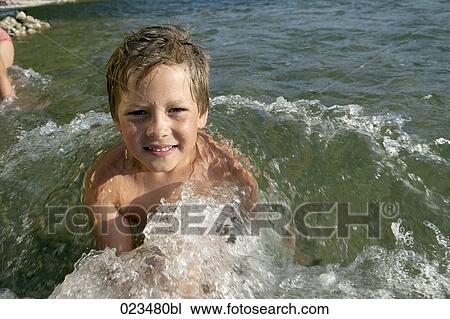 portrait of young boy in water View Large Photo Image Stock Image - portrait of young boy in water. Fotosearch