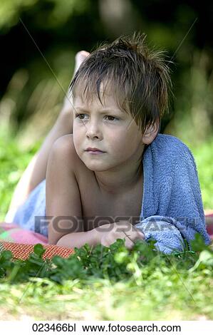 portrait of young boy lying in grass View Large Photo Image Stock Image - portrait of young boy lying in grass. Fotosearch