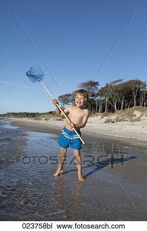 portrait of young boy on beach waving spoon net View Large Photo Image Stock Image - portrait of young boy on beach waving spoon net. Fotosearch