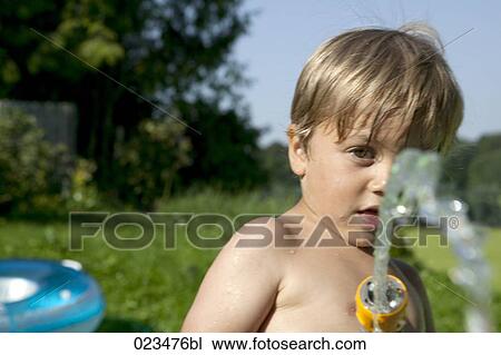 portrait of young boy playing with garden hose View Large Photo Image Stock Image - portrait of young boy playing with garden hose. Fotosearch