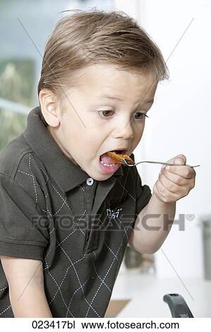 portrait of young boy tasting minced meat View Large Photo Image Stock Image - portrait of young boy tasting minced meat. Fotosearch