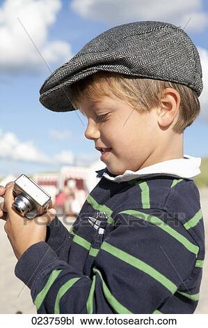 portrait of young boy using digital camera View Large Photo Image Stock Image - portrait of young boy using digital camera. Fotosearch