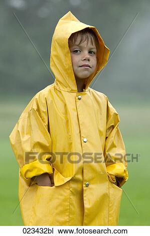 portrait of young boy wearing yellow raincoat View Large Photo Image Stock Image - portrait of young boy wearing yellow raincoat. Fotosearch