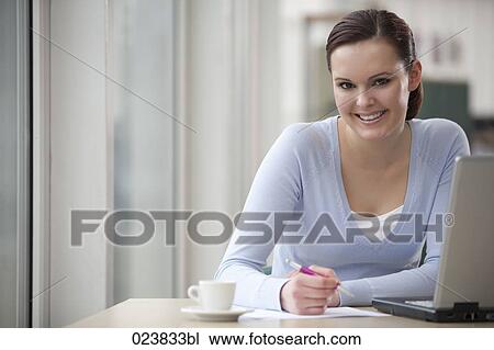 portrait of young businesswoman sitting at desk View Large Photo Image Stock Image - portrait of young businesswoman sitting at desk. Fotosearch