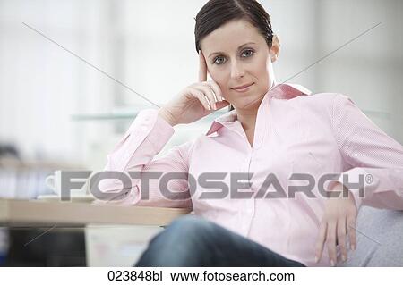 portrait of young businesswoman sitting at table View Large Photo Image Stock Image - portrait of young businesswoman sitting at table. Fotosearch