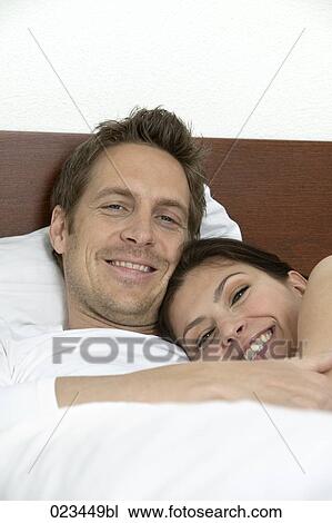 portrait of young couple in bed View Large Photo Image Stock Image - portrait of young couple in bed. Fotosearch