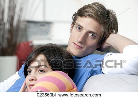 portrait of young couple on sofa at home View Large Photo Image Stock Image - portrait of young couple on sofa at home. Fotosearch