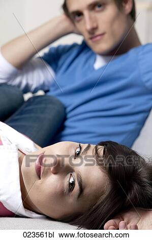 portrait of young couple on sofa at home View Large Photo Image Stock Image - portrait of young couple on sofa at home. Fotosearch