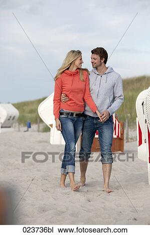 portrait of young couple walking on beach View Large Photo Image Stock Image - portrait of young couple walking on beach. Fotosearch