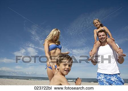 portrait of young family on the beach View Large Photo Image Stock Image - portrait of young family on the beach. Fotosearch