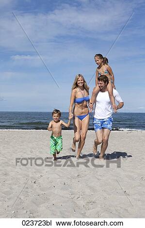 portrait of young family on the beach View Large Photo Image Stock Image - portrait of young family on the beach. Fotosearch