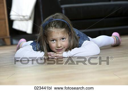 portrait of young girl lying on floor at home View Large Photo Image Stock Image - portrait of young girl lying on floor at home. Fotosearch