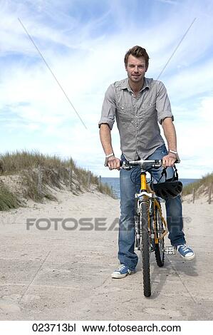 portrait of young man on bicycle at beach View Large Photo Image Stock Image - portrait of young man on bicycle at beach. Fotosearch