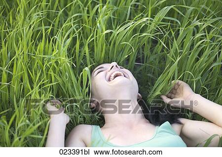 portrait of young woman lying in grass View Large Photo Image Stock Image - portrait of young woman lying in grass. Fotosearch
