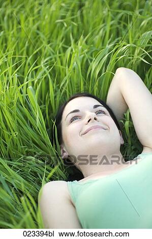 portrait of young woman lying in grass View Large Photo Image Stock Image - portrait of young woman lying in grass. Fotosearch
