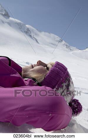 portrait of young woman lying in the snow dozing View Large Photo Image Stock Image - portrait of young woman lying in the snow dozing. Fotosearch