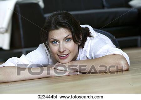 portrait of young woman lying on floor at home View Large Photo Image Stock Image - portrait of young woman lying on floor at home. Fotosearch