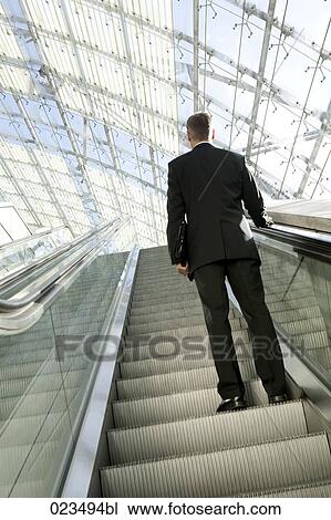 rear view of businessman on escalator View Large Photo Image Stock Image - rear view of businessman on escalator. Fotosearch