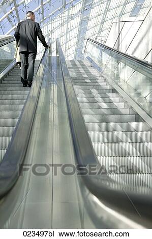 rear view of businessman on escalator View Large Photo Image Stock Image - rear view of businessman on escalator. Fotosearch