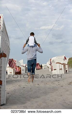 rear view of father carrying young son on his shoulders View Large Photo Image Stock Image - rear view of father carrying young son on his shoulders. Fotosearch