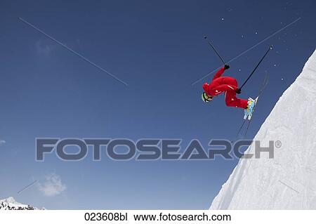 Stock Image - skier racing down the mountains. Fotosearch