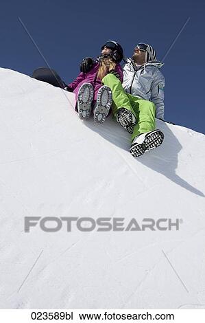 snowboarder couple sitting on snow View Large Photo Image Stock Image - snowboarder couple sitting on snow. Fotosearch