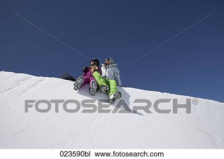 snowboarder couple sitting on snow View Large Photo Image Stock Image - snowboarder couple sitting on snow. Fotosearch