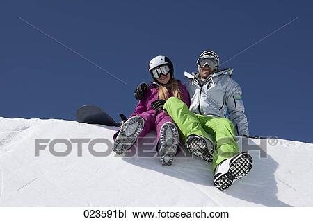 snowboarder couple sitting on snow View Large Photo Image Stock Image - snowboarder couple sitting on snow. Fotosearch