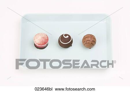 still life of three chocolate candies on a tray View Large Photo Image Stock Image - still life of three chocolate candies on a tray. Fotosearch