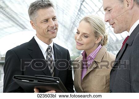 three business people reading document View Large Photo Image Stock Image - three business people reading document. Fotosearch