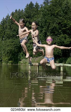 three children jumping into lake View Large Photo Image Stock Image - three children jumping into lake. Fotosearch