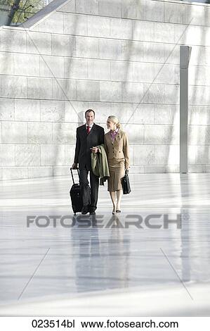 two business people walking through hall View Large Photo Image Stock Image - two business people walking through hall. Fotosearch