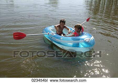 two young boys together in rubber boat View Large Photo Image Stock Image - two young boys together in rubber boat. Fotosearch
