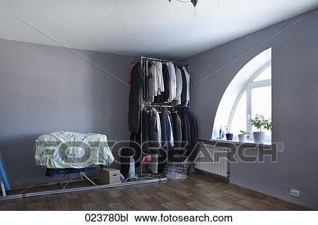 view into room with clothes in open wardrobe View Large Photo Image Stock Image - view into room with clothes in open wardrobe. Fotosearch