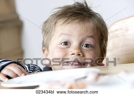 young boy peeking over table View Large Photo Image Stock Image - young boy peeking over table. Fotosearch