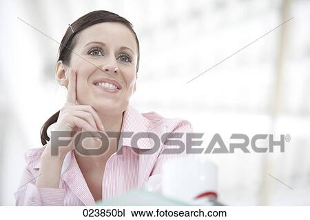 Stock Image - young businesswoman having break. Fotosearch