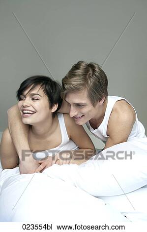 young couple in bed together View Large Photo Image Stock Image - young couple in bed together. Fotosearch